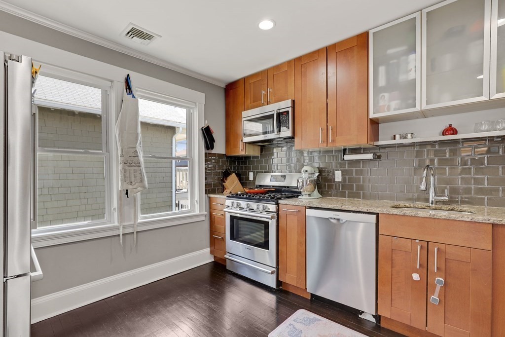 7-9 Goodway Road, Unit 2 Boston, MA 02130 - Photo 13 of 33 a kitchen with granite countertop cabinets stainless steel appliances and a sink