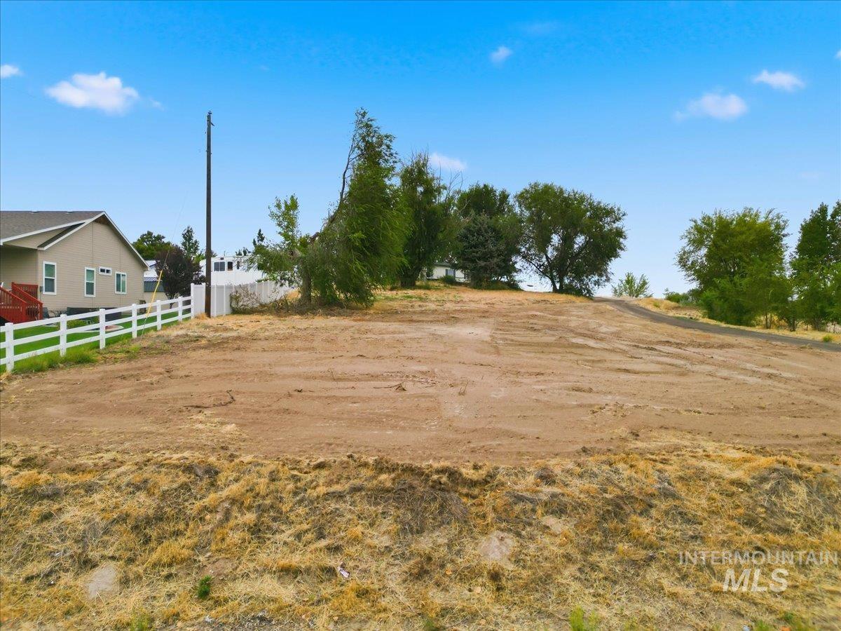 17114 Goodson Road Caldwell, ID 83607 - Photo 36 of 36 Cleared land parcel with a white fence border