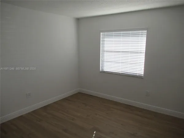 wooden floor and window in an empty room