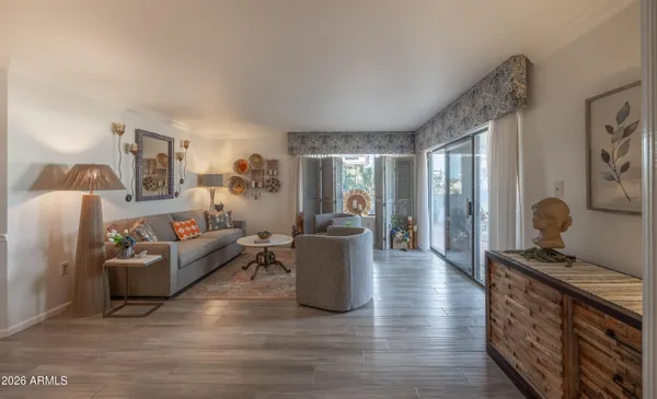 a living room with furniture and wooden floor