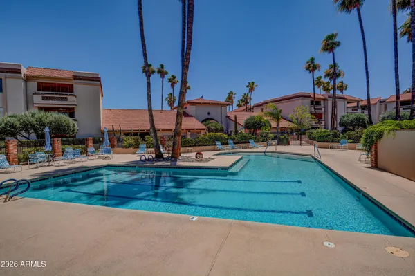 a view of swimming pool with outdoor seating