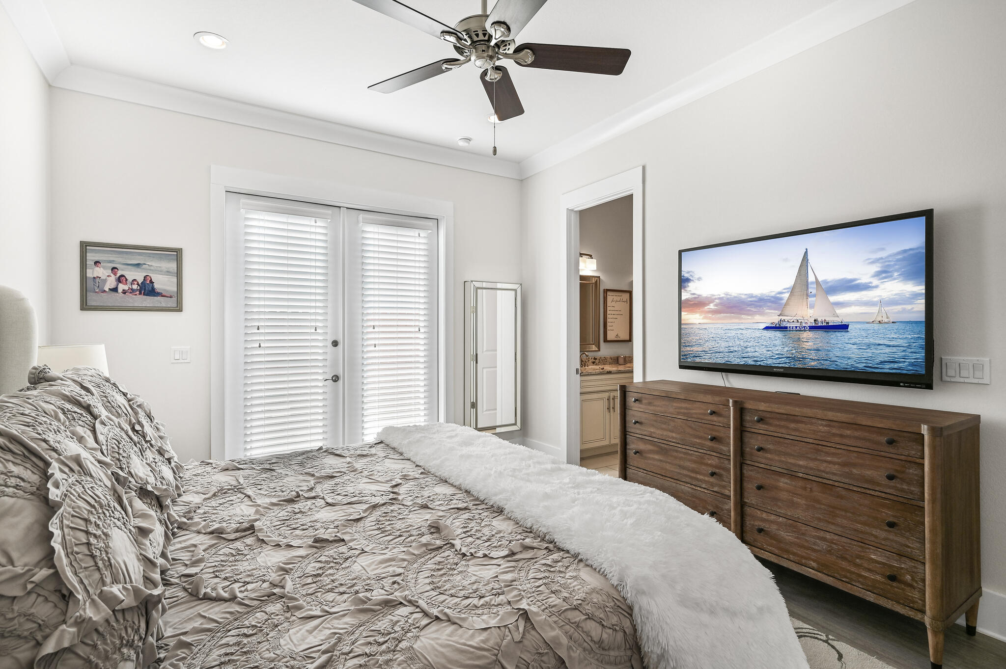 995 Airport Road, Unit 13 Destin, FL 32541 - Photo 11 of 34 a bedroom with a bed and a chandelier