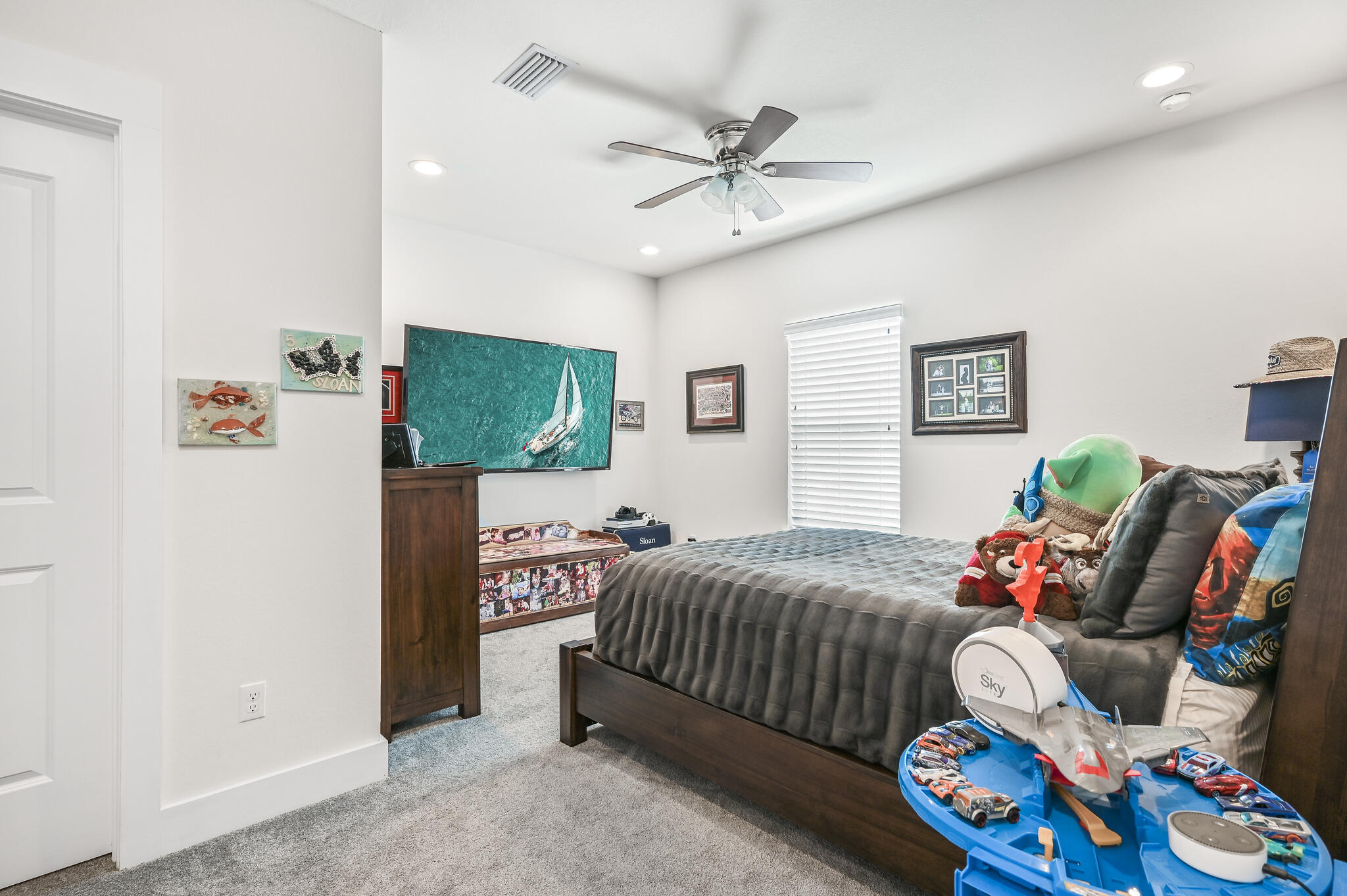 995 Airport Road, Unit 13 Destin, FL 32541 - Photo 21 of 34 a bedroom with a bed and a chandelier