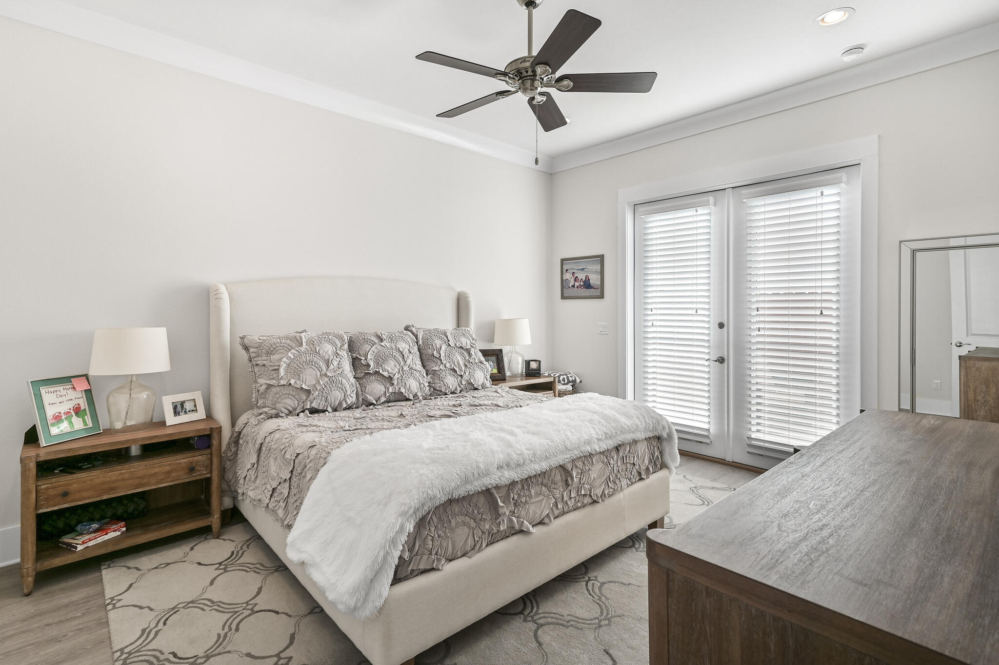 995 Airport Road, Unit 13 Destin, FL 32541 - Photo 10 of 34 a bedroom with a bed and a chandelier