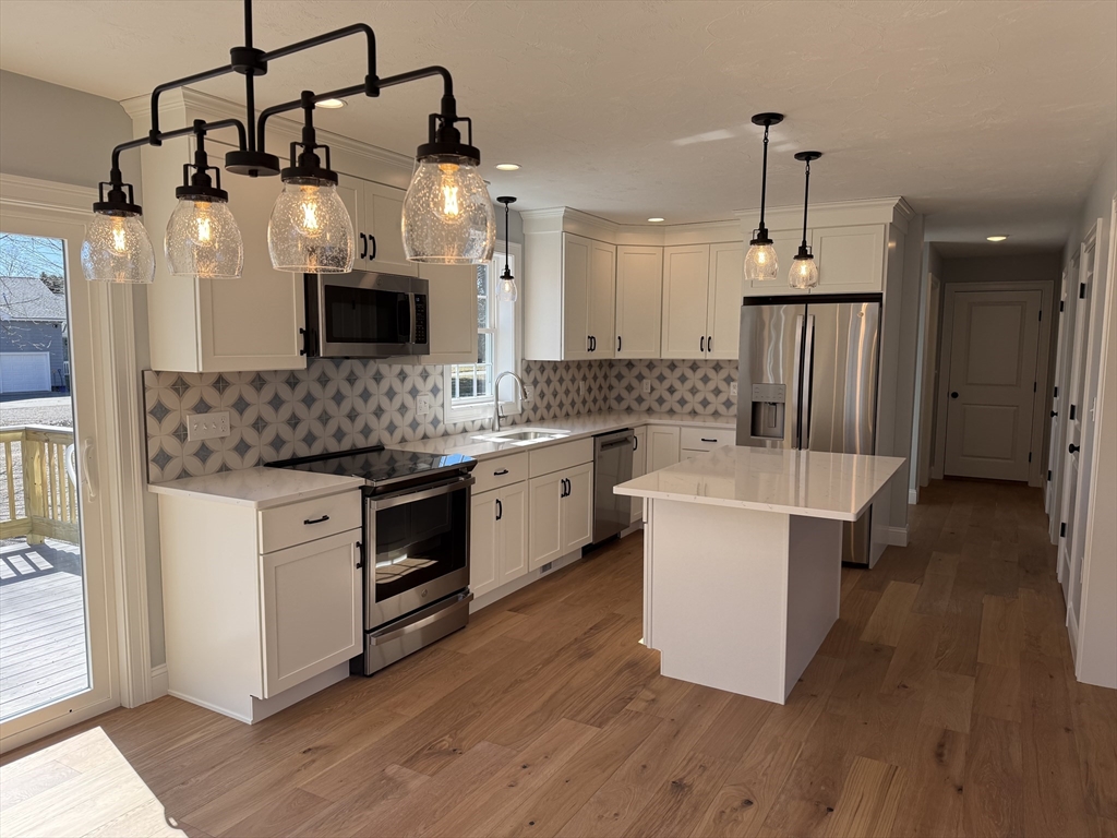 3 Jennifer Circle Bridgewater, MA 02324 - Photo 2 of 9 a kitchen with a sink and a stove top oven