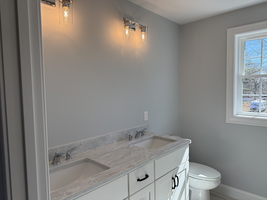 3 Jennifer Circle Bridgewater, MA 02324 - Photo 9 of 9 a bathroom with a granite countertop sink toilet and a mirror