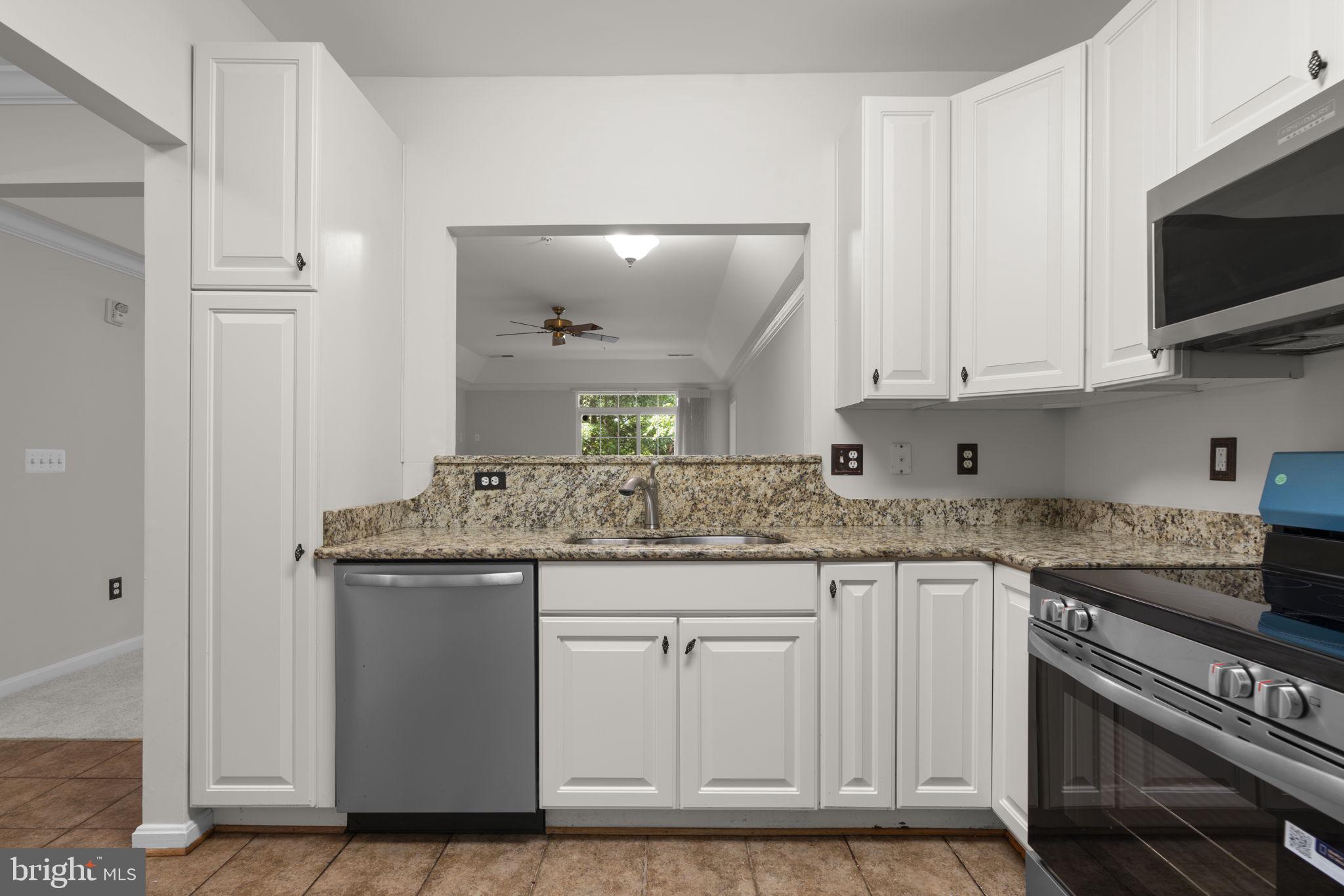 7315 Maplecrest Road, Unit 104 Elkridge, MD 21075 - Photo 20 of 58 a kitchen with stainless steel appliances granite countertop a stove and a sink