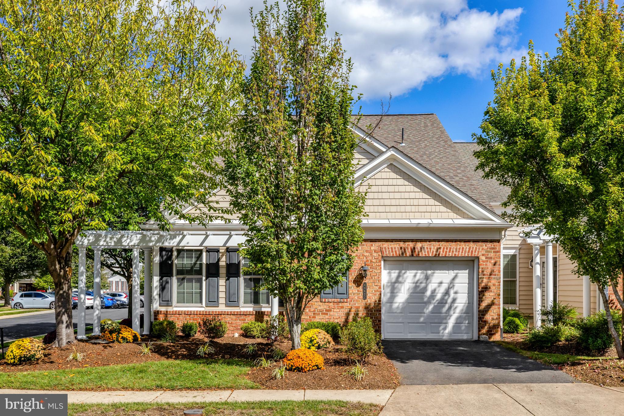 a front view of a house with a yard garage and outdoor seating