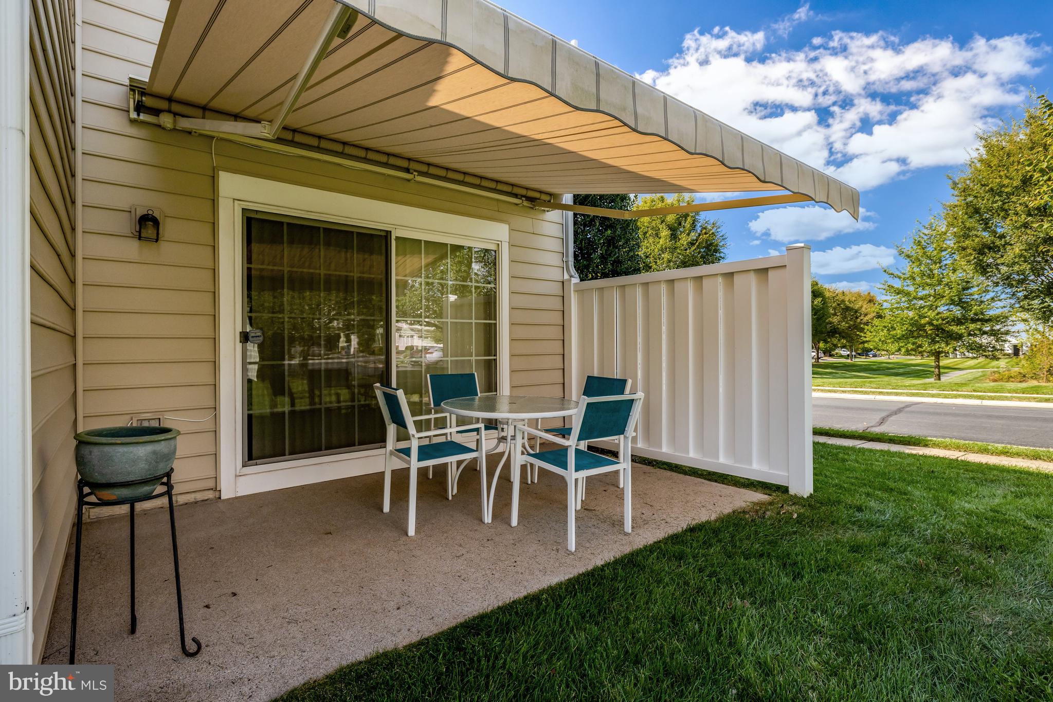 44482 Maltese Falcon Square Ashburn, VA 20147 - Photo 47 of 71 a view of a patio with table and chairs with wooden fence and plants