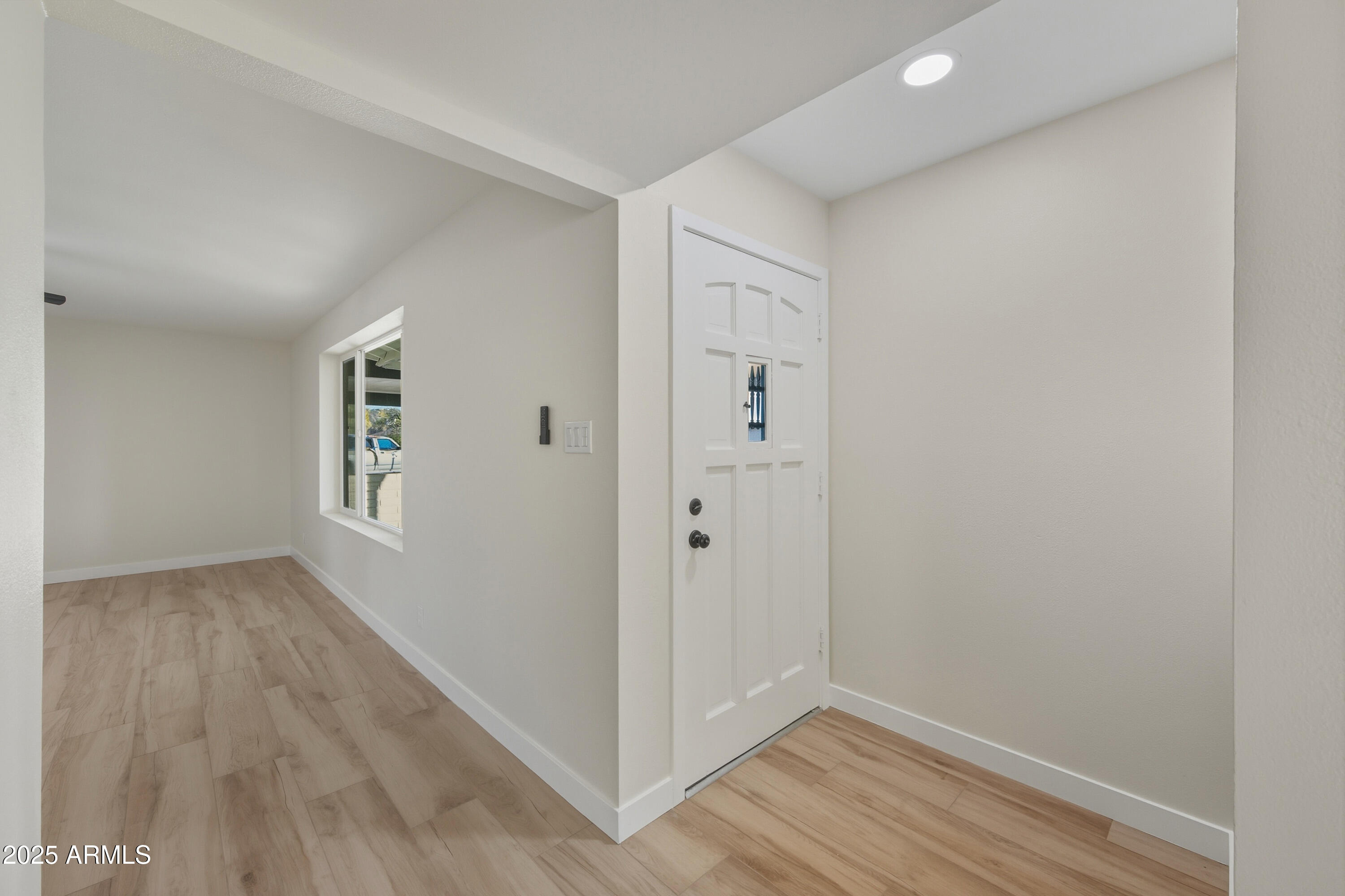 3410 West Pershing Avenue Phoenix, AZ 85029 - Photo 12 of 33 a view of an empty room with wooden floor