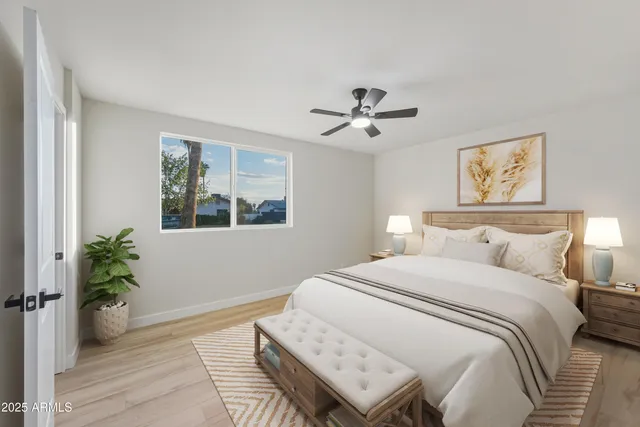 a bedroom with a large bed and a window