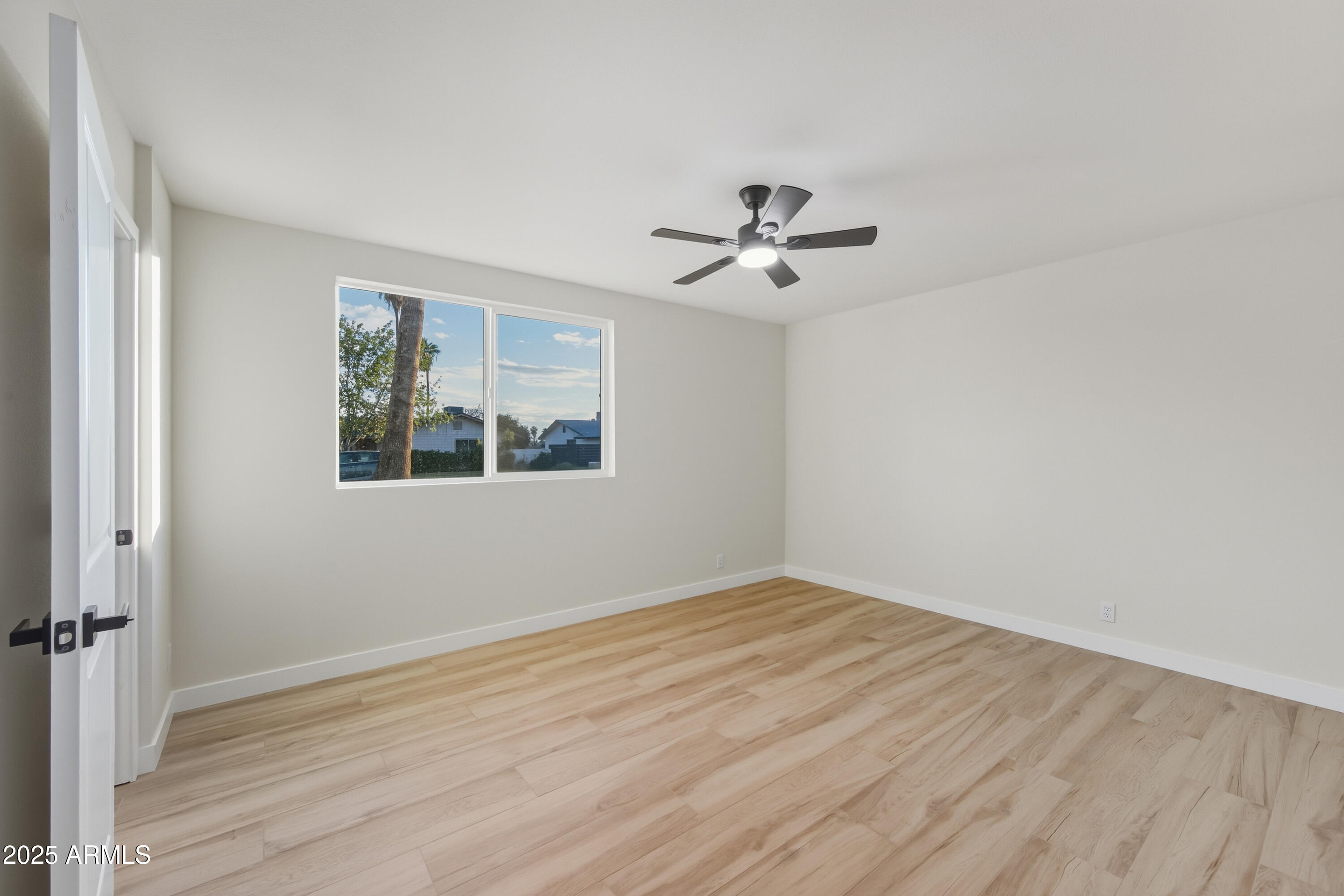 3410 West Pershing Avenue Phoenix, AZ 85029 - Photo 14 of 33 a view of empty room with wooden floor and fan