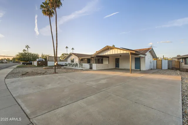 a view of a house with a palm tree