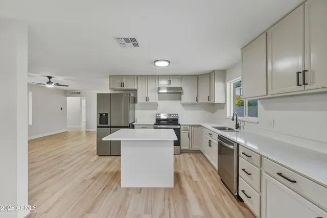 a kitchen with a sink stove and refrigerator
