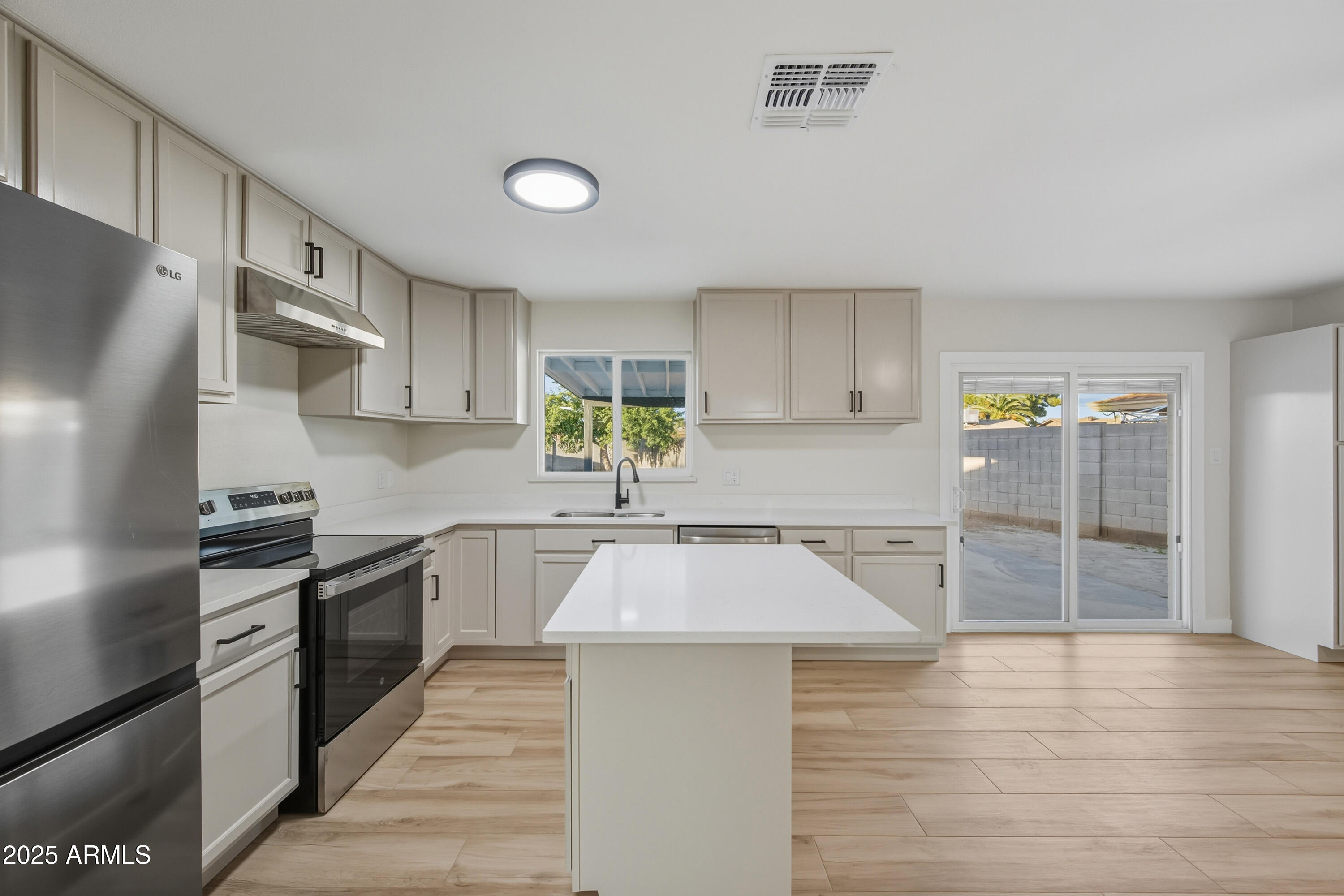 3410 West Pershing Avenue Phoenix, AZ 85029 - Photo 5 of 33 a large kitchen with cabinets and stainless steel appliances