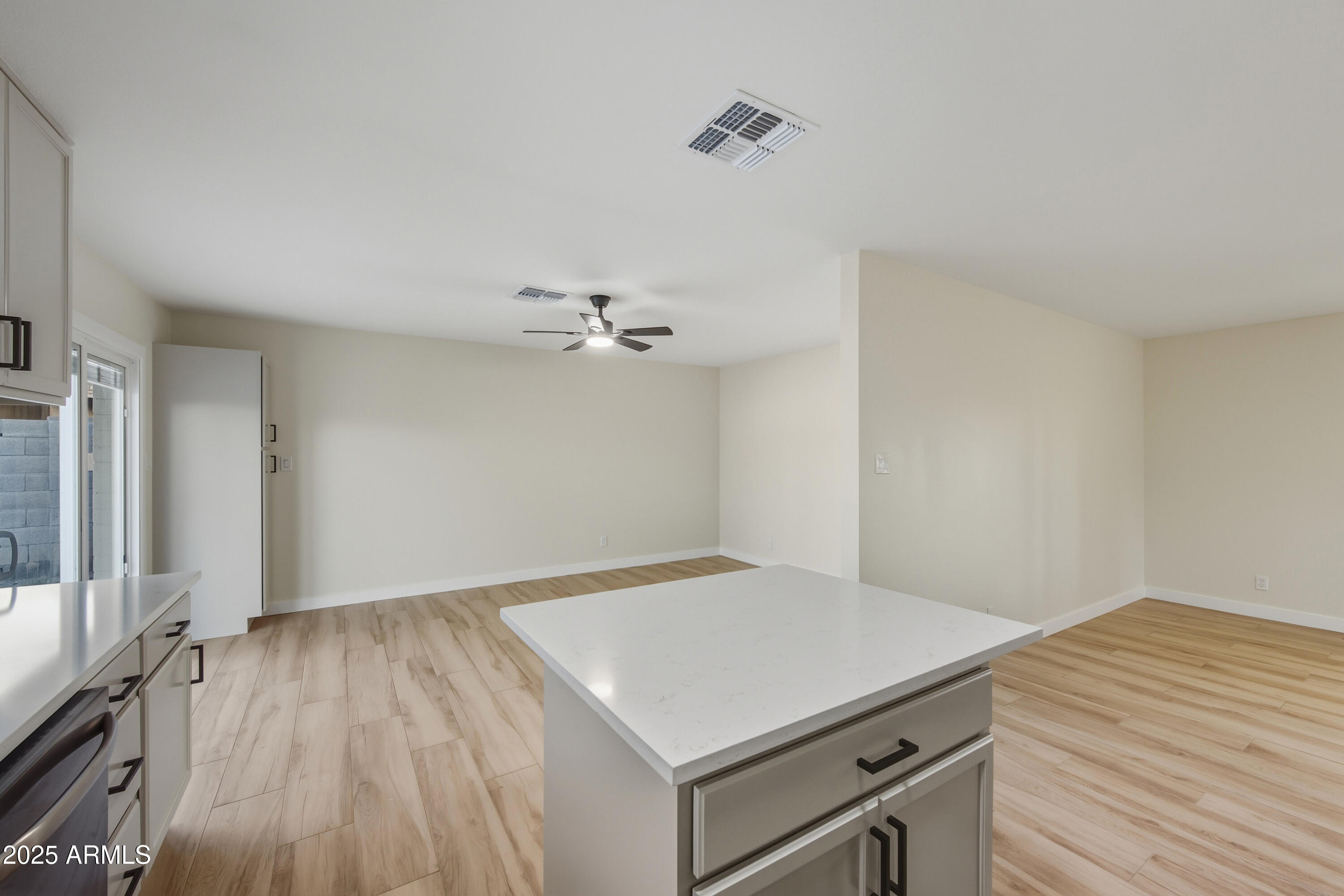 3410 West Pershing Avenue Phoenix, AZ 85029 - Photo 6 of 33 a view of a room with wooden floor and ceiling fan