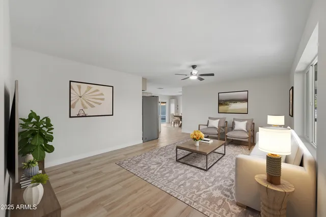 a living room with furniture and a potted plant