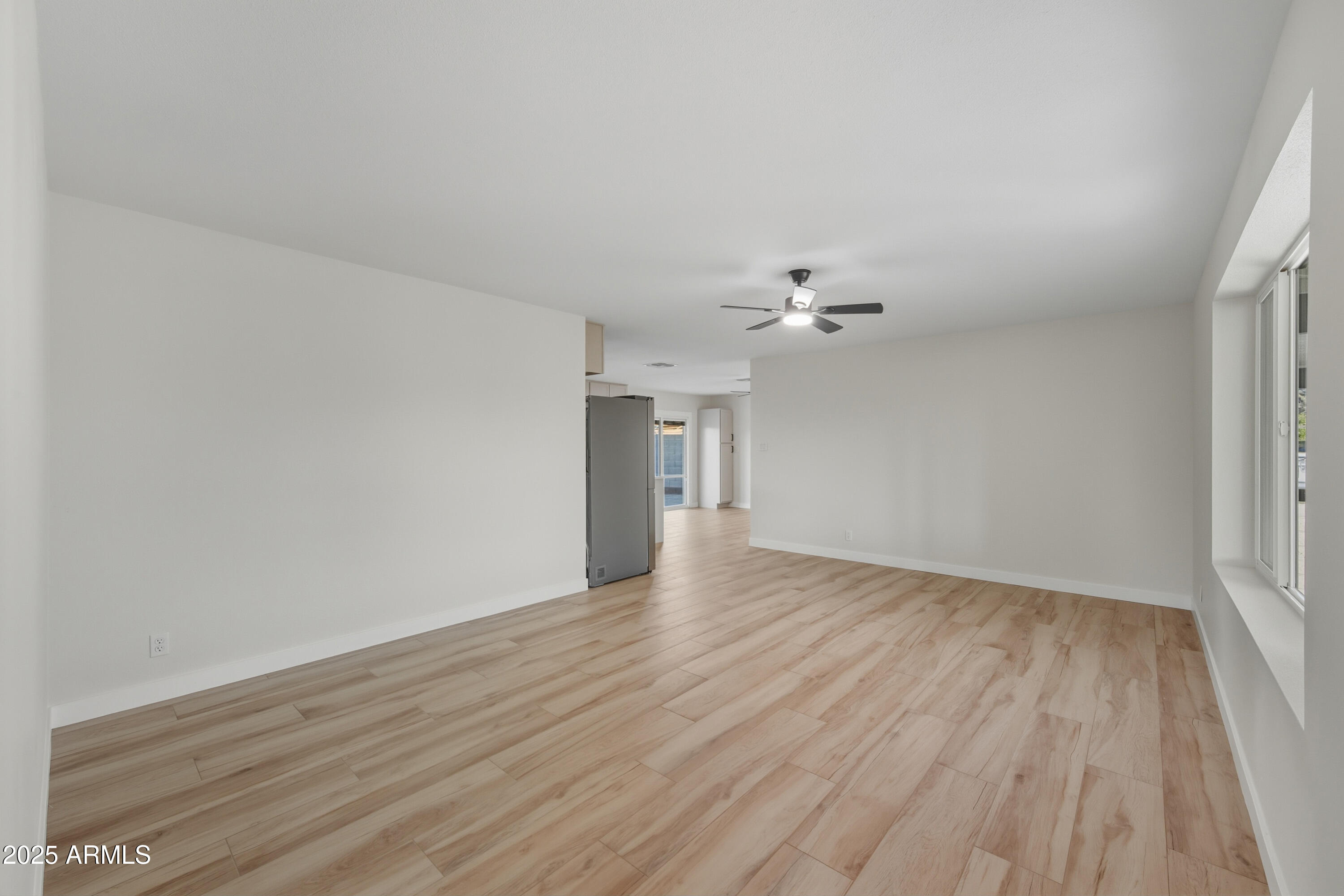 3410 West Pershing Avenue Phoenix, AZ 85029 - Photo 9 of 33 wooden floor in an empty room with a window