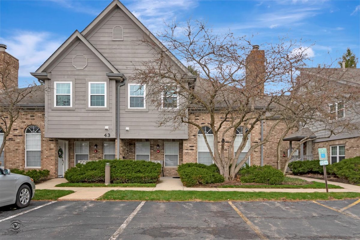 43 Foxcroft Road, Unit 219 Naperville, IL 60565 - Photo 1 of 19 a front view of a house with a yard and garage