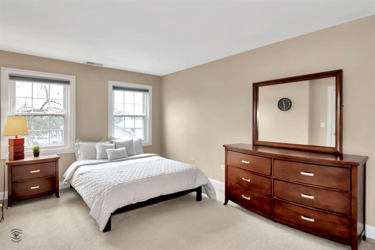 43 Foxcroft Road, Unit 219 Naperville, IL 60565 - Photo 11 of 19 a bedroom with a bed and window
