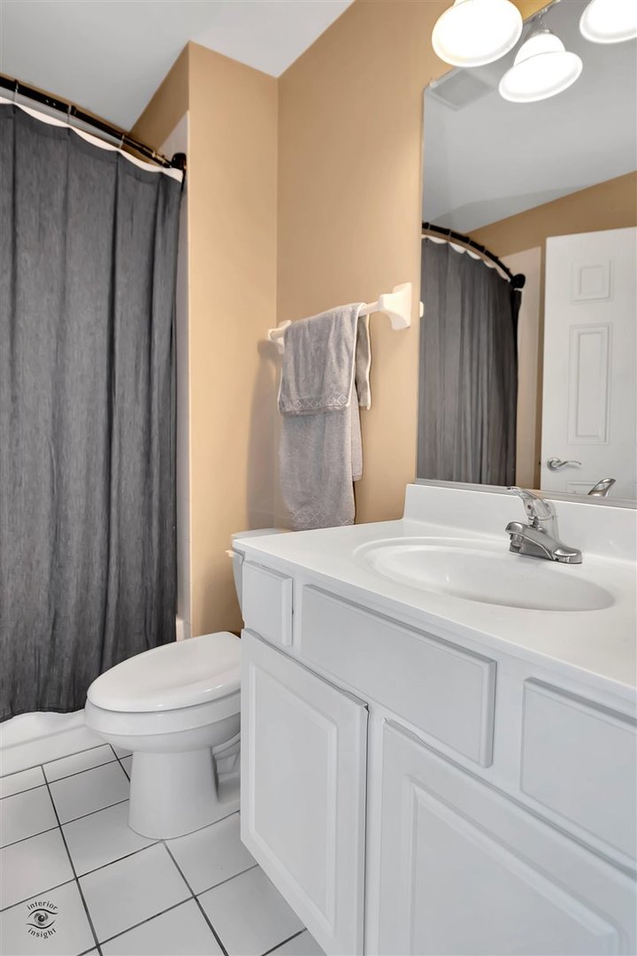 43 Foxcroft Road, Unit 219 Naperville, IL 60565 - Photo 14 of 19 a bathroom with a sink a toilet and shower