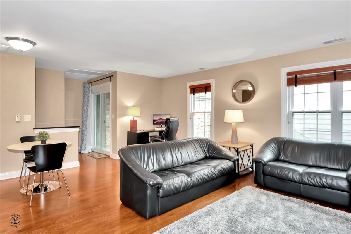 43 Foxcroft Road, Unit 219 Naperville, IL 60565 - Photo 5 of 19 a living room with a couch and a window