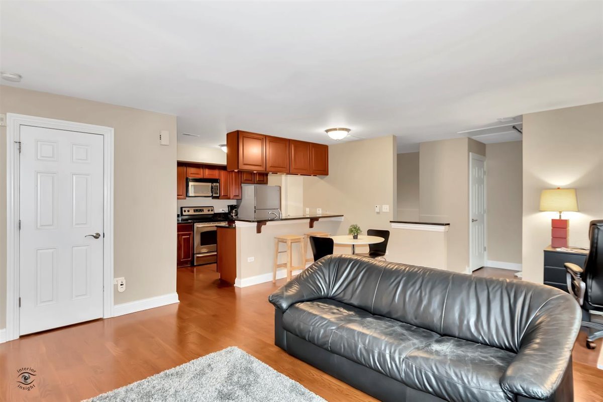 43 Foxcroft Road, Unit 219 Naperville, IL 60565 - Photo 6 of 19 a living room with furniture and a wooden floor