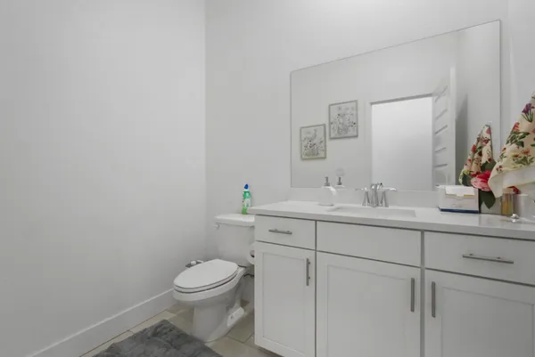 a bathroom with a sink a toilet and mirror