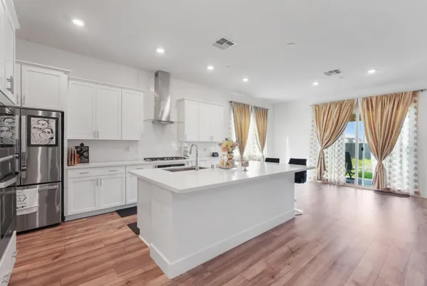a kitchen with a sink stainless steel appliances a window and a counter top space