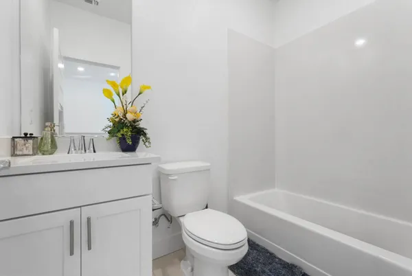 a bathroom with a sink a toilet and bathtub