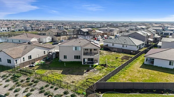 an aerial view of residential houses with yard