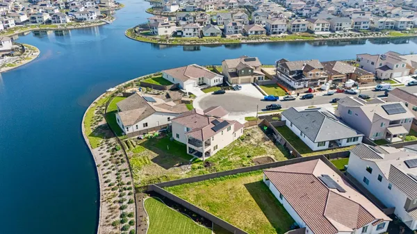 an aerial view of a house with a lake view