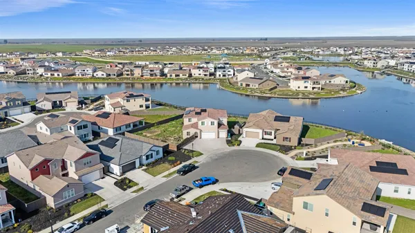 an aerial view of a house with outdoor seating