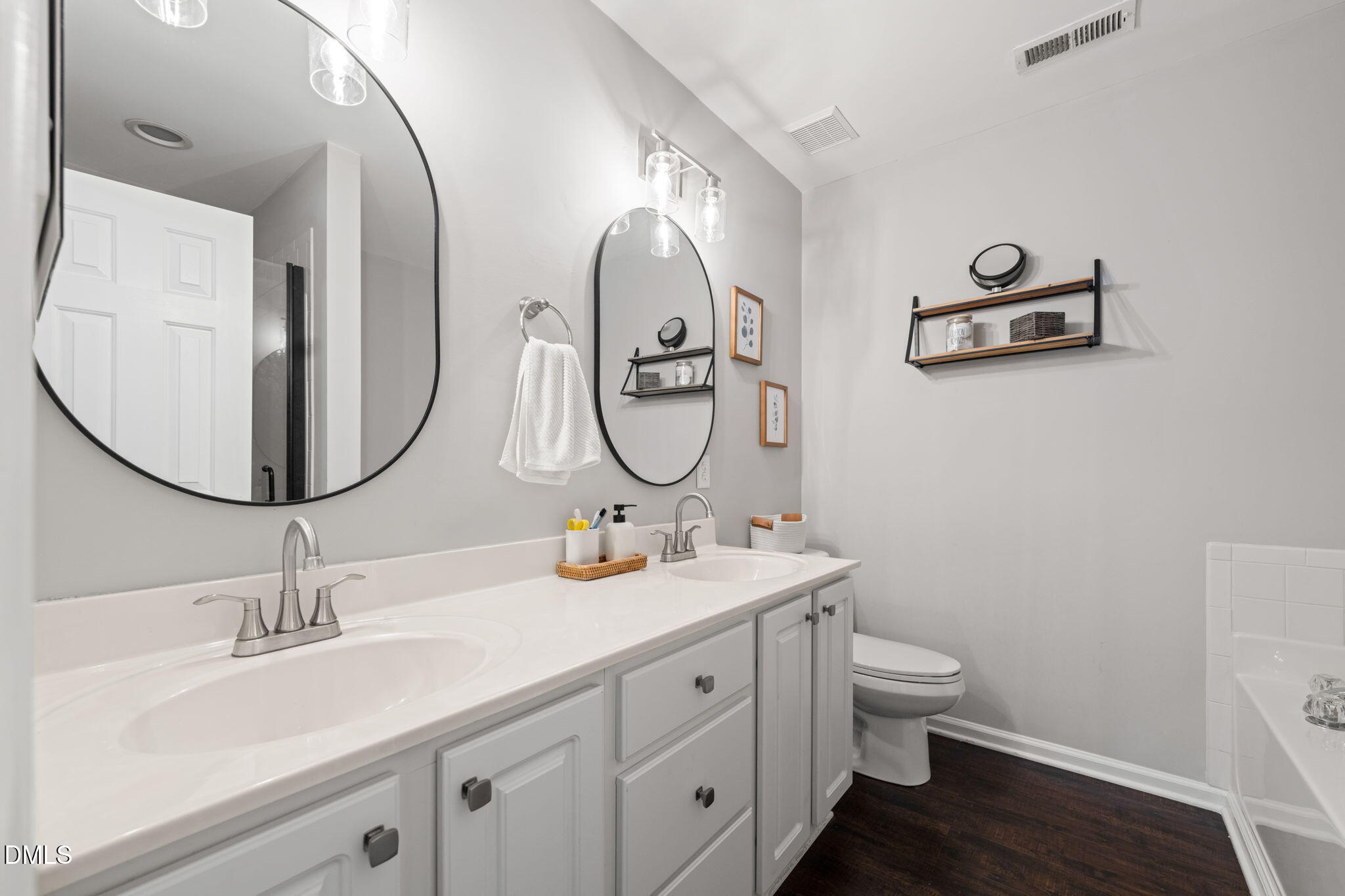 4323 Pine Springs Court Raleigh, NC 27613 - Photo 29 of 38 a bathroom with 2 sink and a mirror