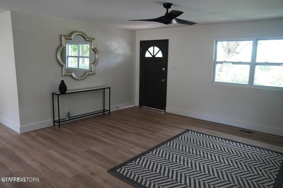 228 Brampton Road Knoxville, TN 37934 - Photo 6 of 23 an empty room with wooden floor cabinet and windows