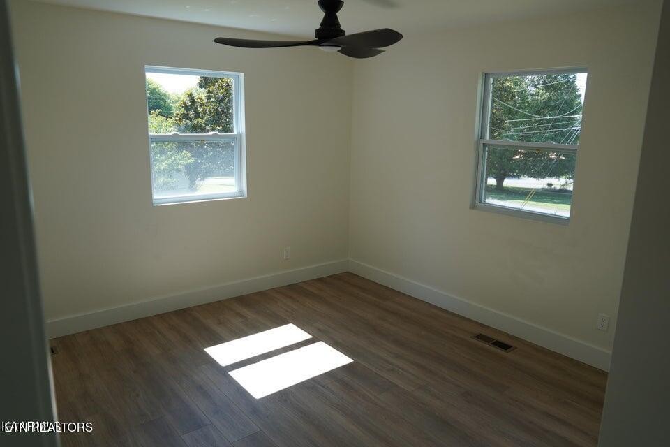 228 Brampton Road Knoxville, TN 37934 - Photo 9 of 23 an empty room with wooden floor and windows