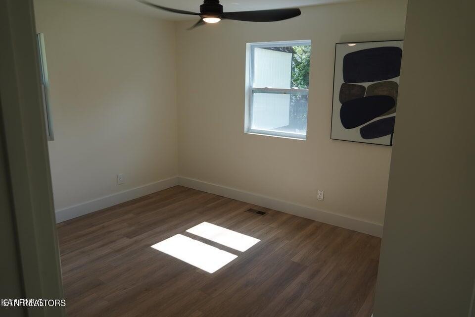 228 Brampton Road Knoxville, TN 37934 - Photo 10 of 23 an empty room with wooden floor and windows