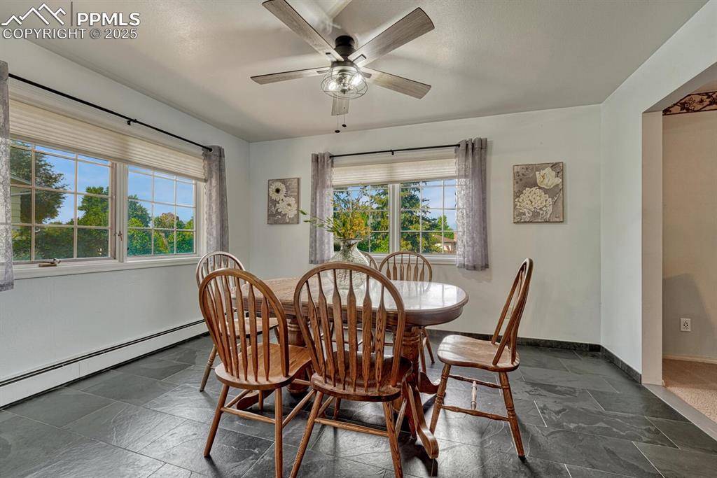 4307 Valli Vista Road Colorado Springs, CO 80915 - Photo 12 of 47 a view of a dining room with furniture window and outside view