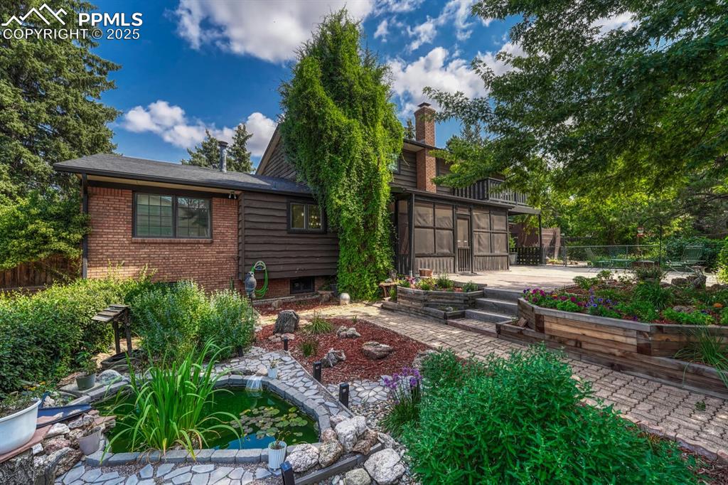 4307 Valli Vista Road Colorado Springs, CO 80915 - Photo 2 of 47 a view of a backyard with plants and large tree