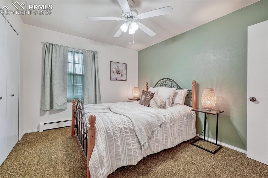 4307 Valli Vista Road Colorado Springs, CO 80915 - Photo 25 of 47 a bedroom with a bed and a chandelier