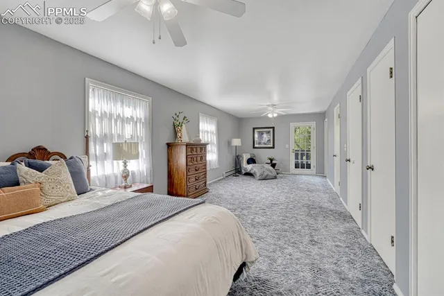 a bedroom with a large bed and a chandelier