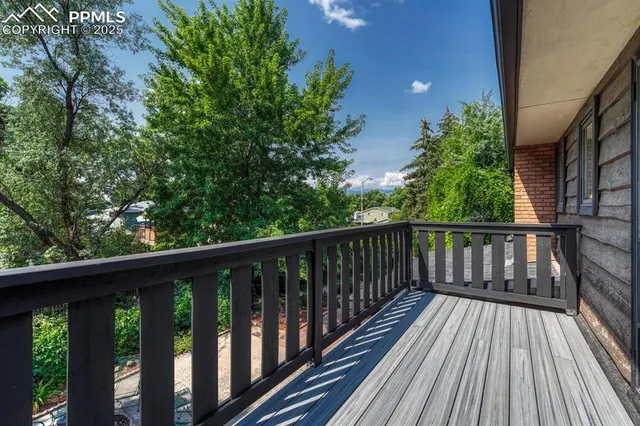 a view of balcony with wooden floor and fence