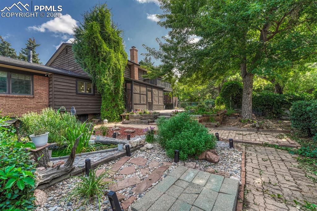 4307 Valli Vista Road Colorado Springs, CO 80915 - Photo 37 of 47 a backyard of a house with lots of green space