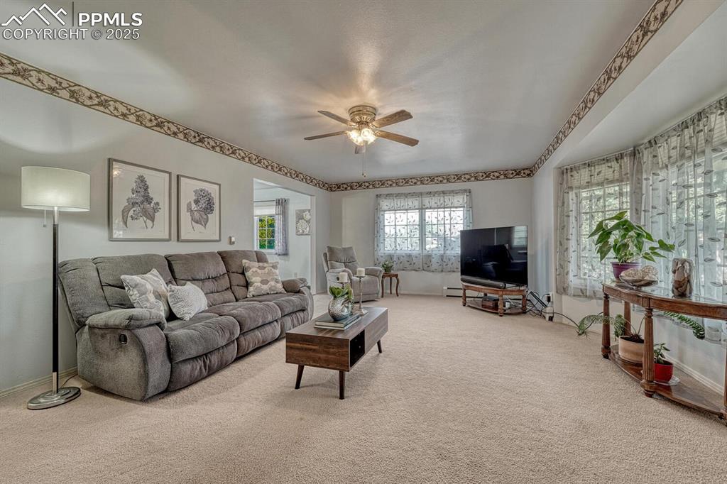 4307 Valli Vista Road Colorado Springs, CO 80915 - Photo 7 of 47 a living room with furniture and a flat screen tv