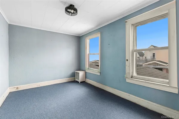 a view of room with window and air conditioner