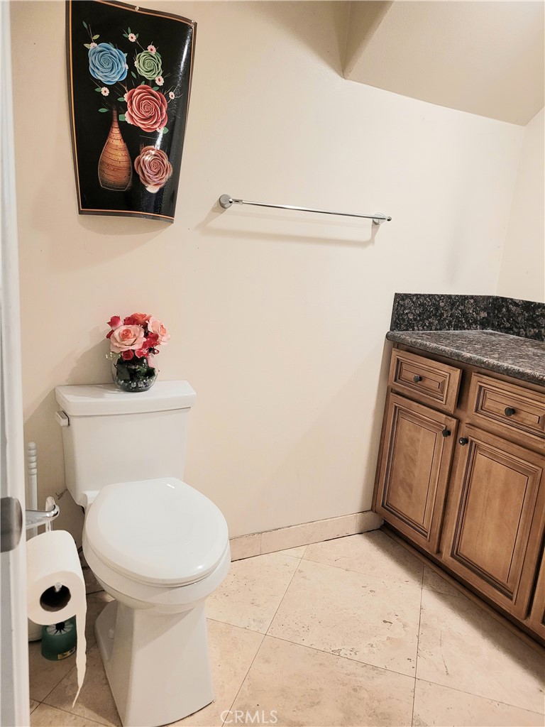 11896 Firebrand Circle Garden Grove, CA 92840 - Photo 12 of 37 a bathroom with a toilet a sink and vanity