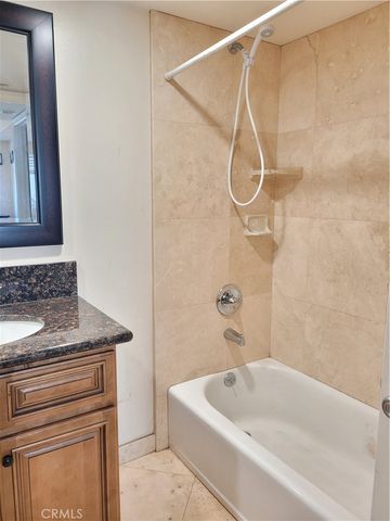a bathroom with a granite countertop sink a toilet and shower