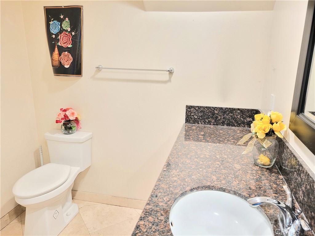 11896 Firebrand Circle Garden Grove, CA 92840 - Photo 14 of 37 a bathroom with a toilet sink and mirror