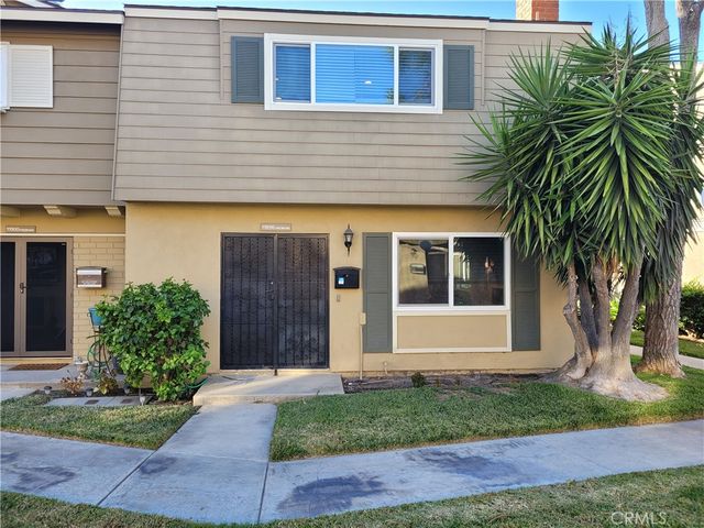a view of a house with a yard and plants