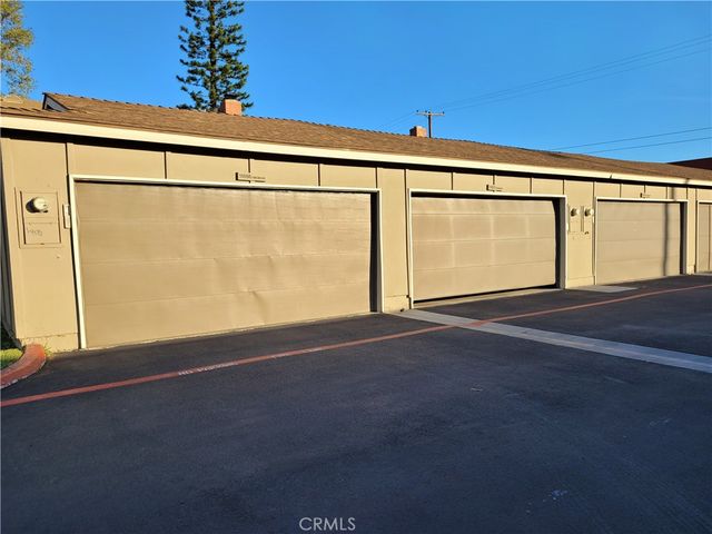 a view of a backyard with a garden and entertaining space